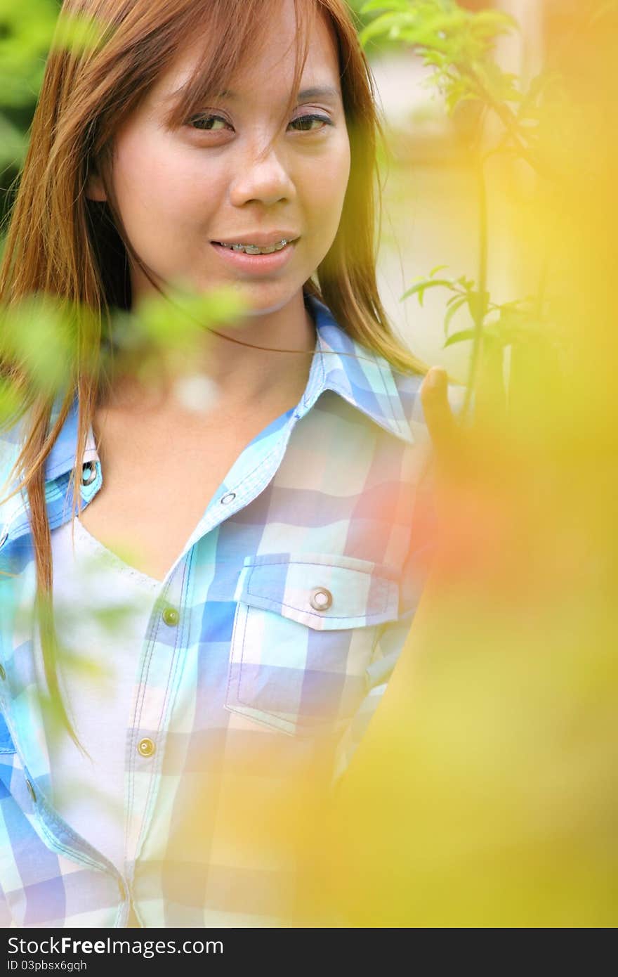 Asia woman with brown hair smiling yellow foreground. Asia woman with brown hair smiling yellow foreground