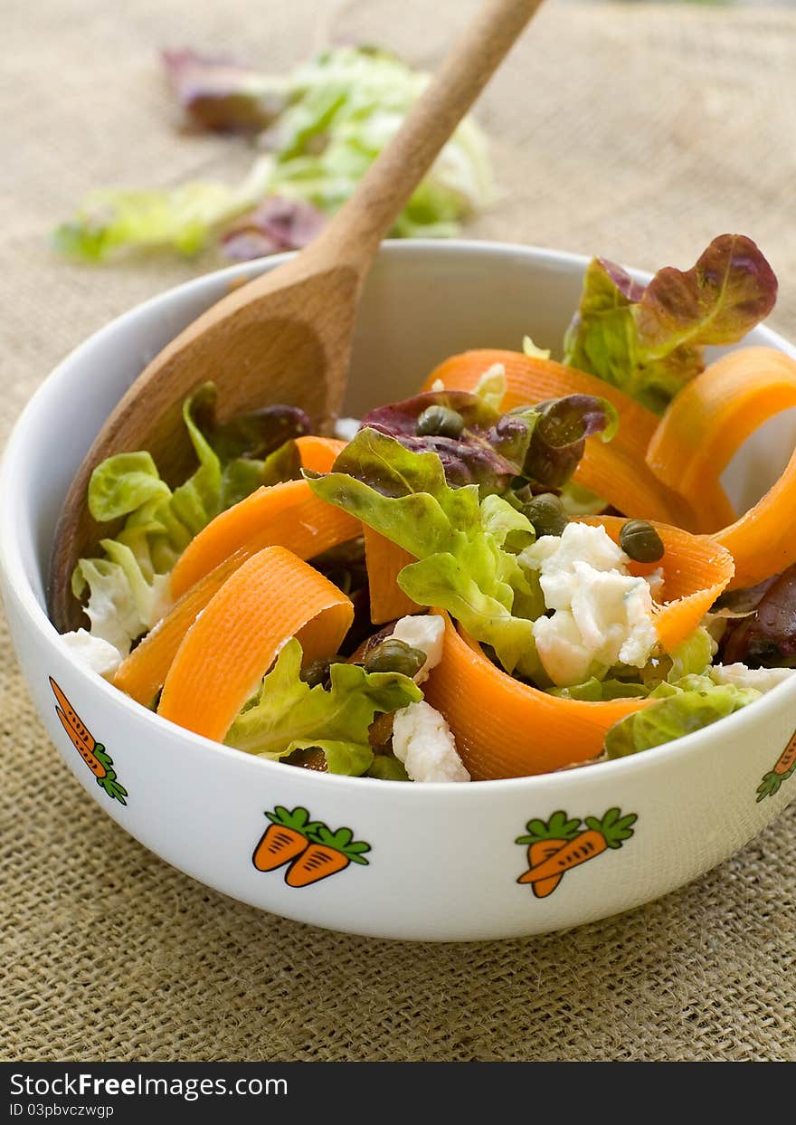 Carrot salad with lettuce and feta cheese. Selective focus