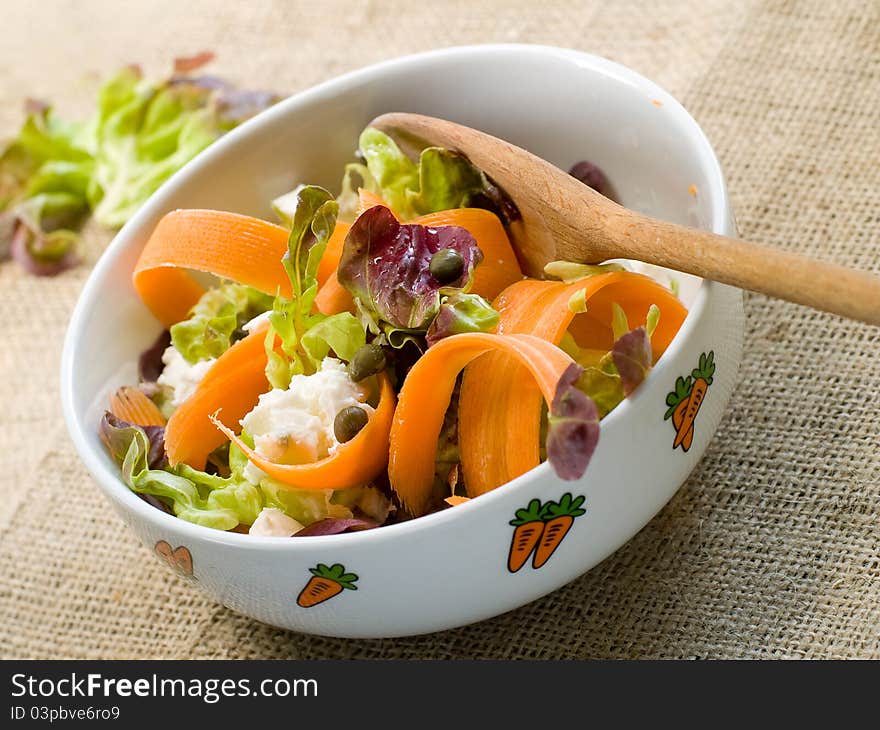 Carrot salad with lettuce and feta cheese. Selective focus