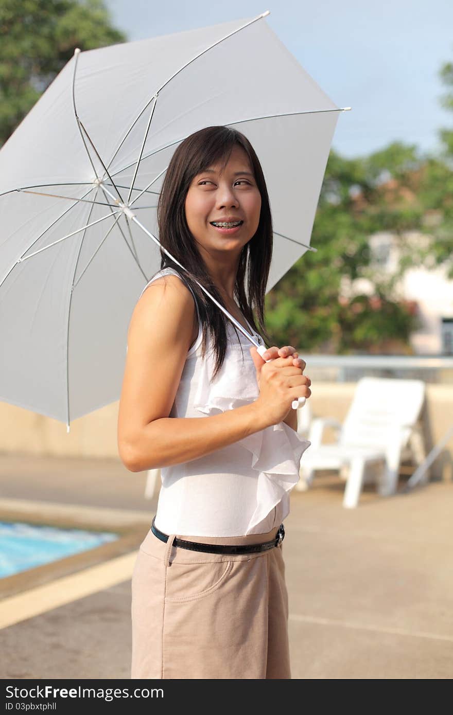 Women And Umbrella Beside Swimming Pool