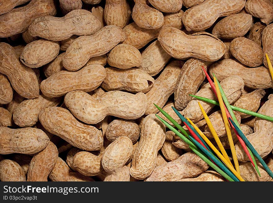 Nuts Peanuts are scattered as a background on a table.