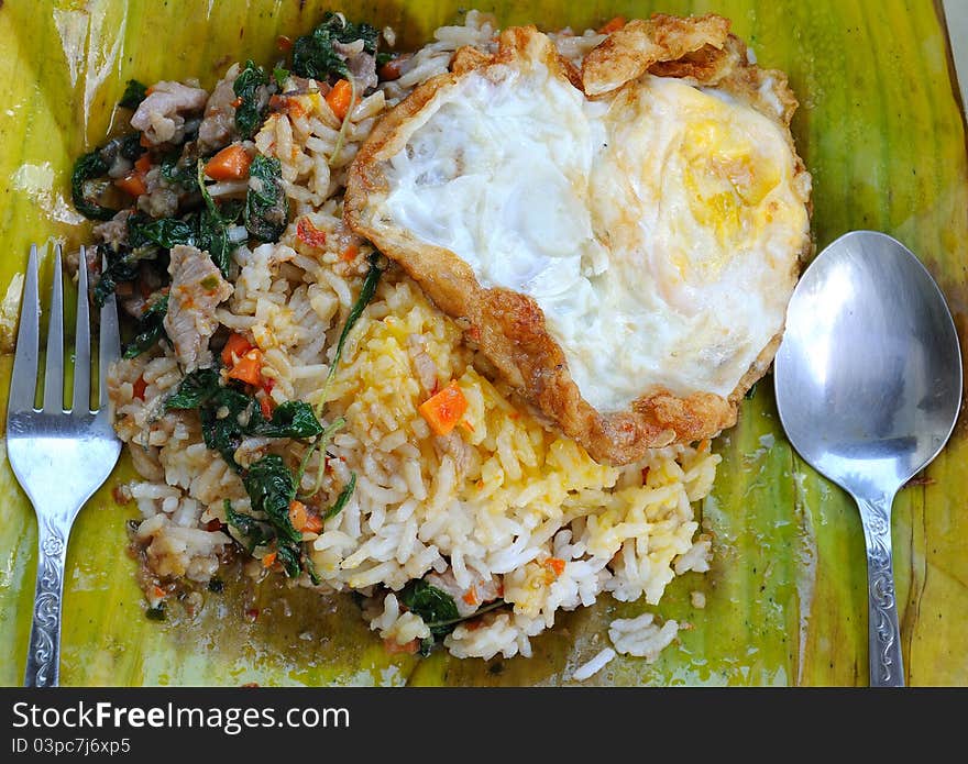 Basil pork with rice on banana leaf in thai style