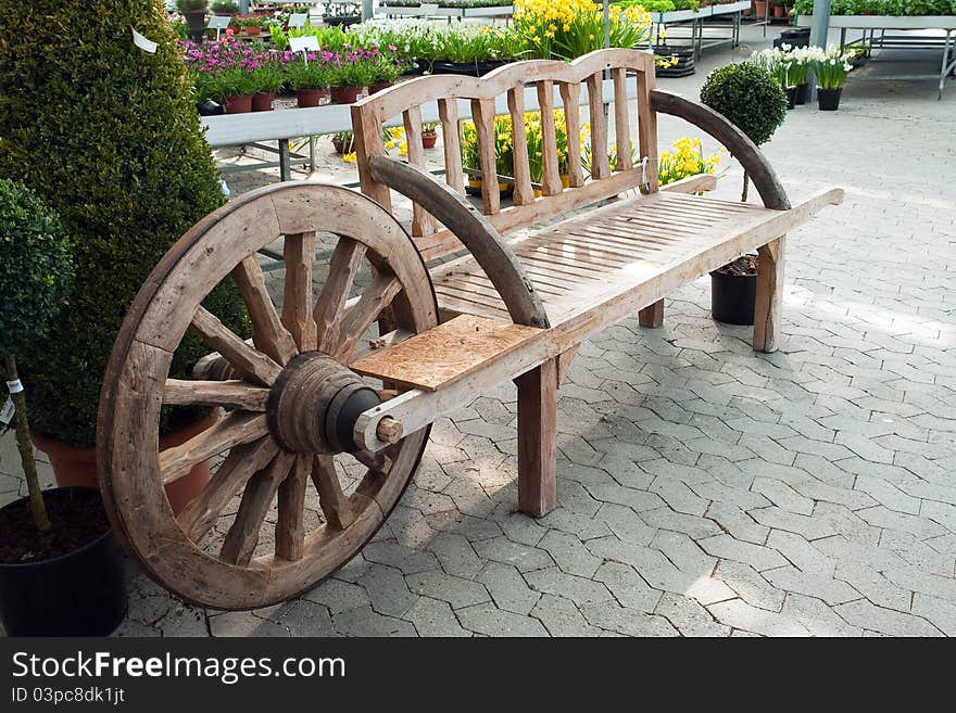 Creative handmade wooden garden bench shaped like a wagon wheel. Creative handmade wooden garden bench shaped like a wagon wheel