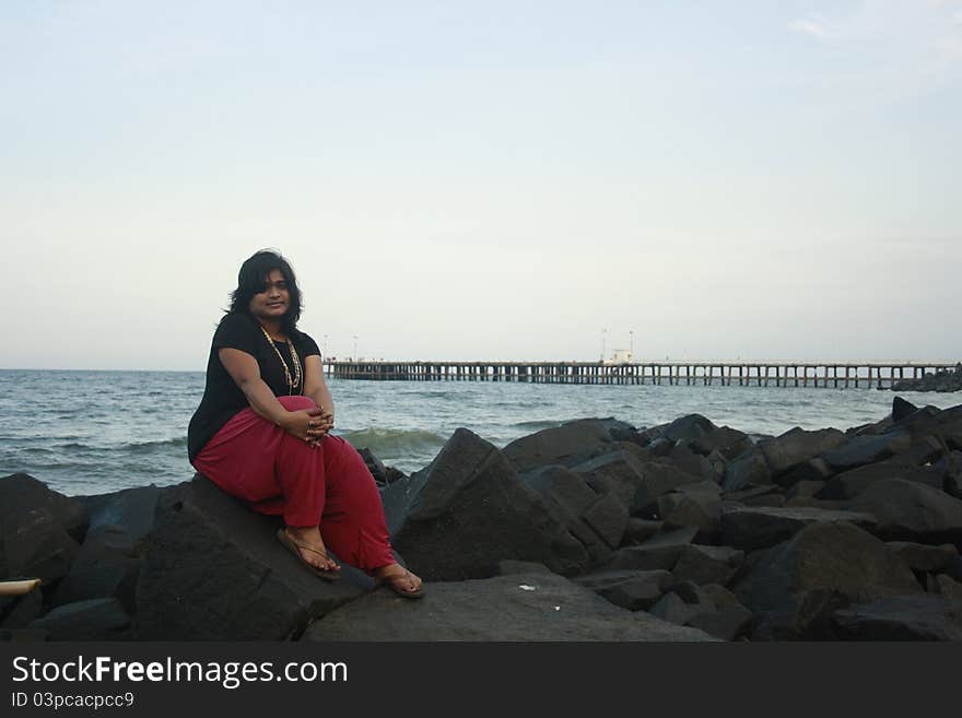 Isolation and Solitude of an Indian Woman looking at the endless sea.