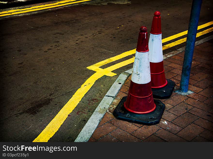 Twin of traffic cones on pavement