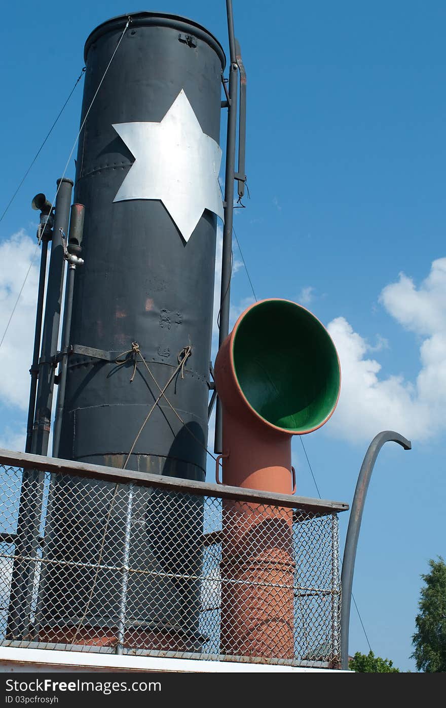 Tube antique steamer against the blue sky. Tube antique steamer against the blue sky