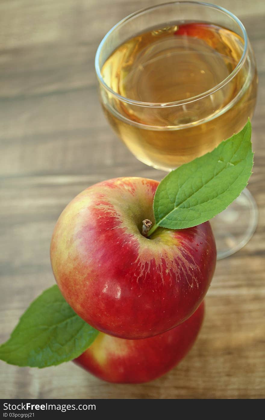 Red apple and grapes on a wooden background. Red apple and grapes on a wooden background