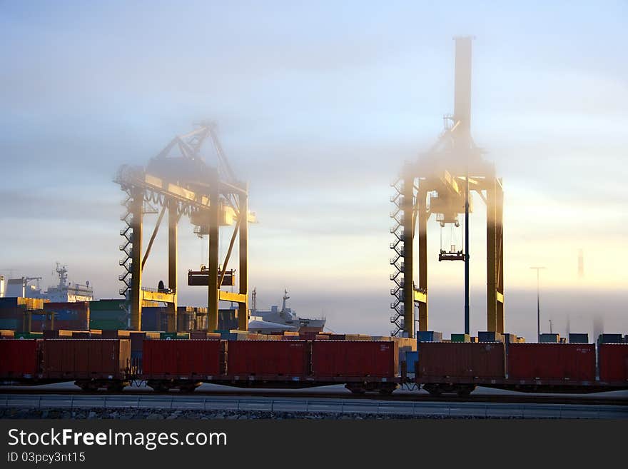 Two big harbor cranes in foggy morning. Two big harbor cranes in foggy morning.