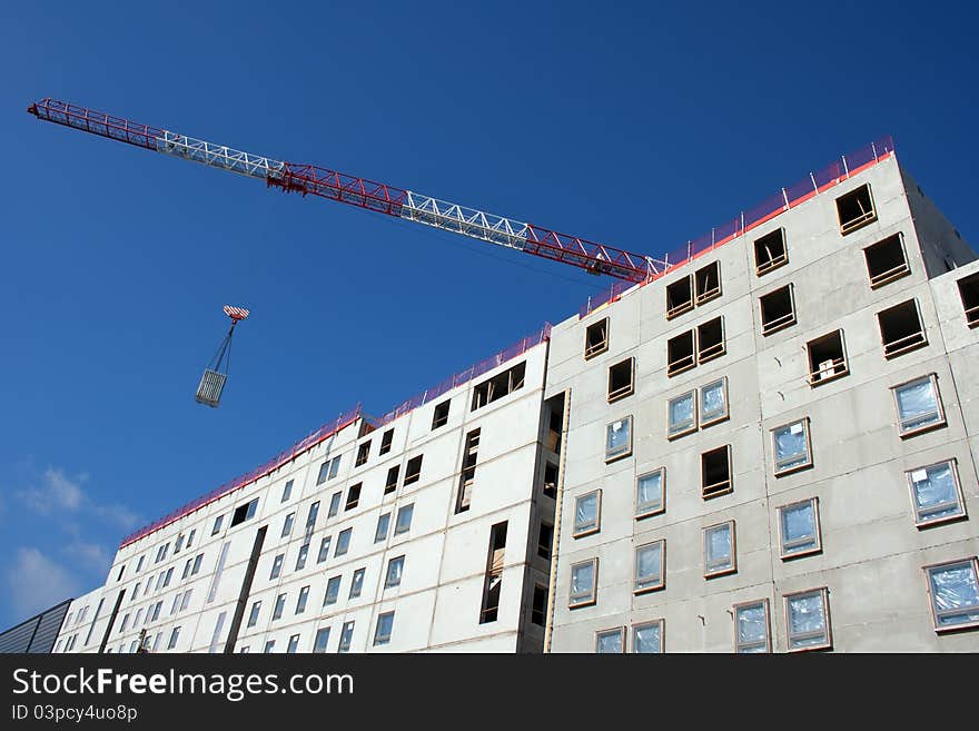 Apartment construction site with blue sky and crane. Apartment construction site with blue sky and crane