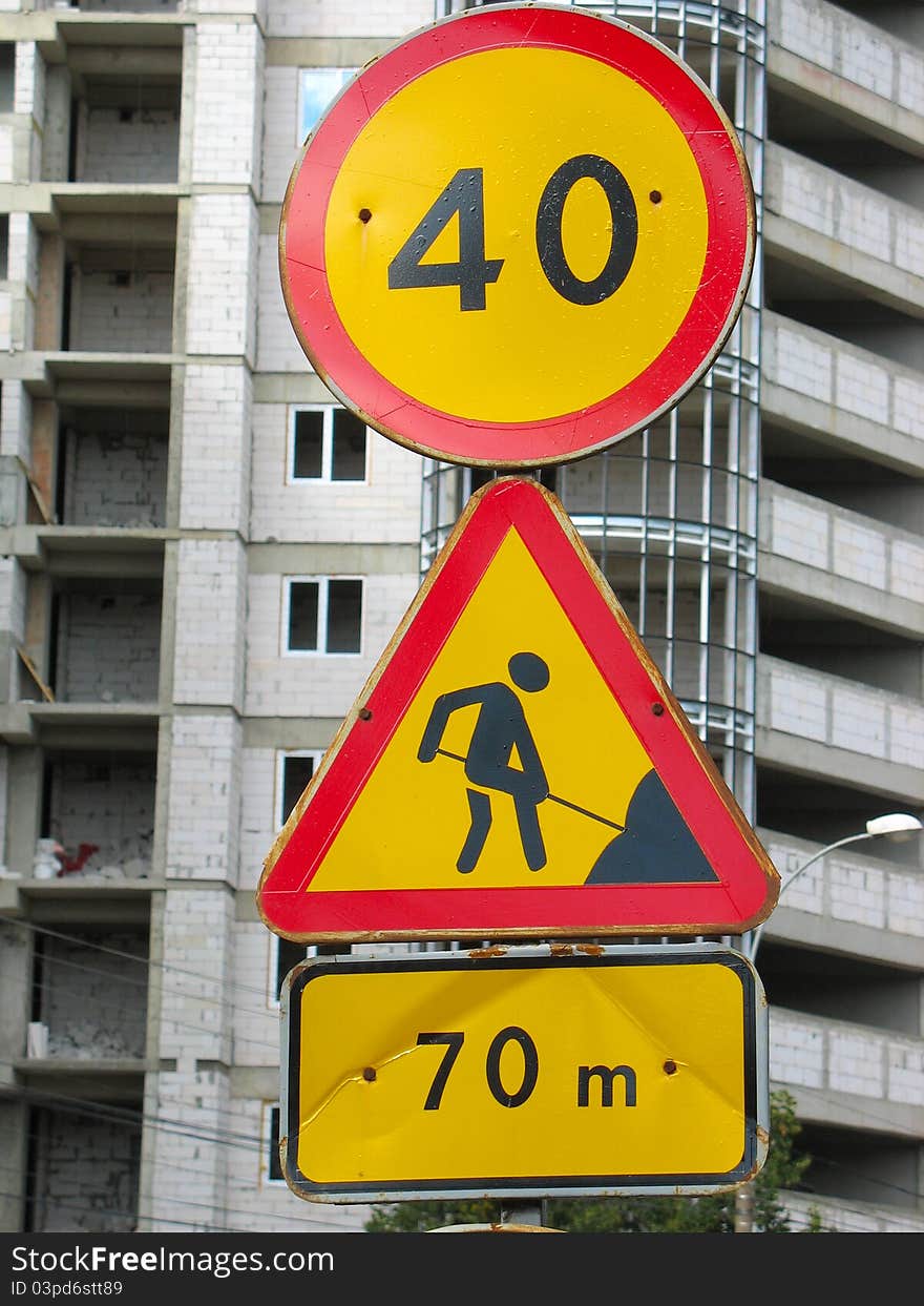 Under construction road sign on building new house background