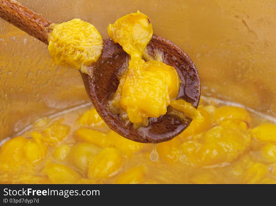 Studio-shot of cooking and preparing homemade small yellow plum ( mellow mirabelle ) jam in a pot. Studio-shot of cooking and preparing homemade small yellow plum ( mellow mirabelle ) jam in a pot.