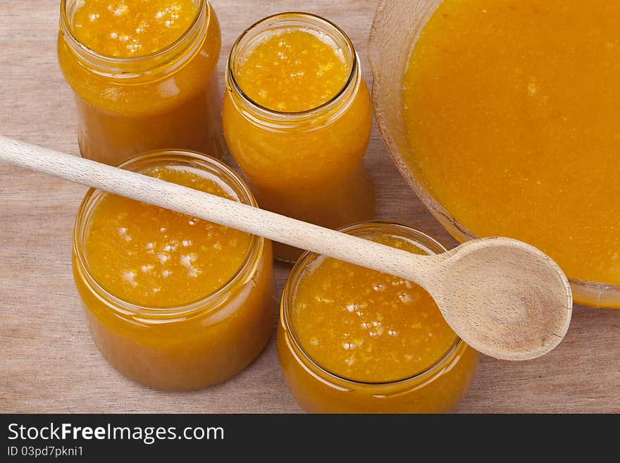 Studio-shot of homemade small yellow plum ( mellow mirabelle ) jam in a glass jar and in a bowl. Studio-shot of homemade small yellow plum ( mellow mirabelle ) jam in a glass jar and in a bowl.