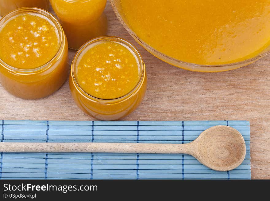 Studio-shot of homemade small yellow plum ( mellow mirabelle ) jam in a glass jar and in a bowl. Studio-shot of homemade small yellow plum ( mellow mirabelle ) jam in a glass jar and in a bowl