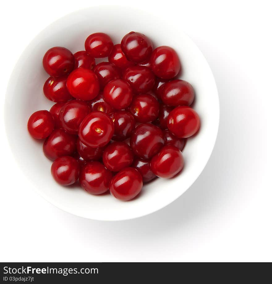 Handful of red cherries in a plate on a white background. Handful of red cherries in a plate on a white background