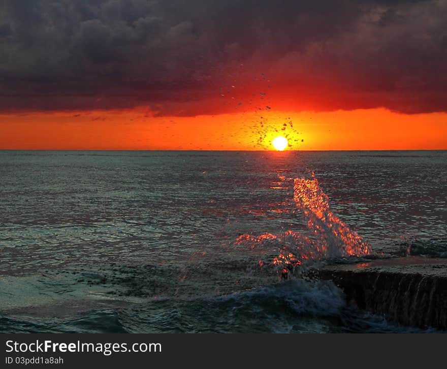 Decline on the sea. Wave splashes about a stone. Decline on the sea. Wave splashes about a stone.