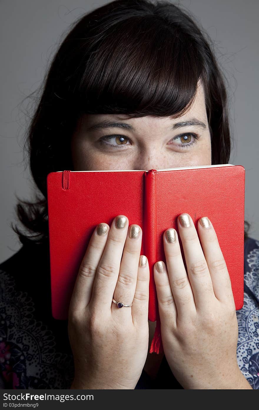 A girl with her nose in a book.