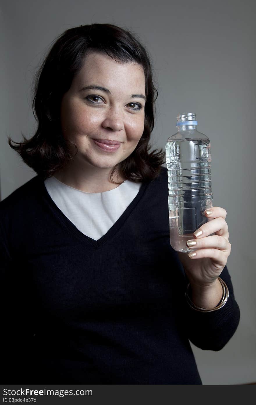 A young girl holding a water bottle. A young girl holding a water bottle.