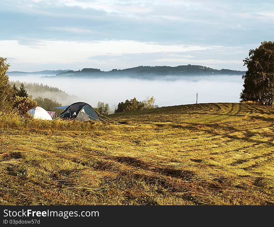 Tents standing in a landscape covered in fog