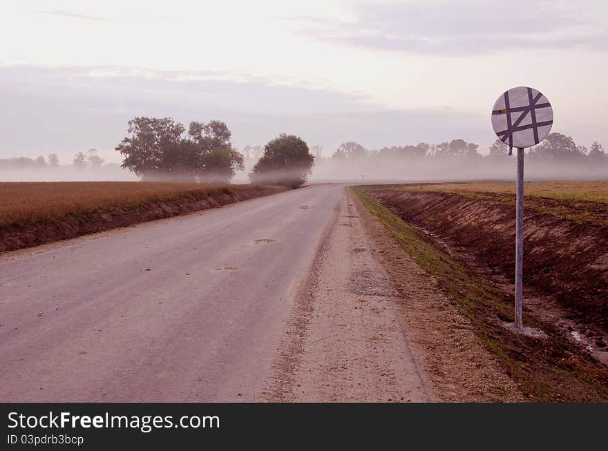 Early summer morning mist and road. Early summer morning mist and road