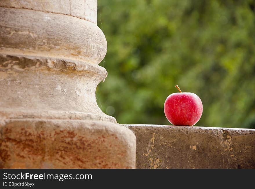 Red apple and old historical column. Red apple and old historical column