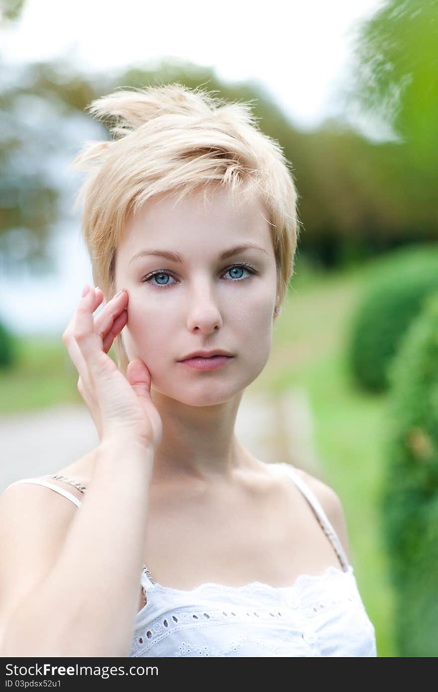 Portrait of young female posing on the nature. Model stroking her body. Portrait of young female posing on the nature. Model stroking her body