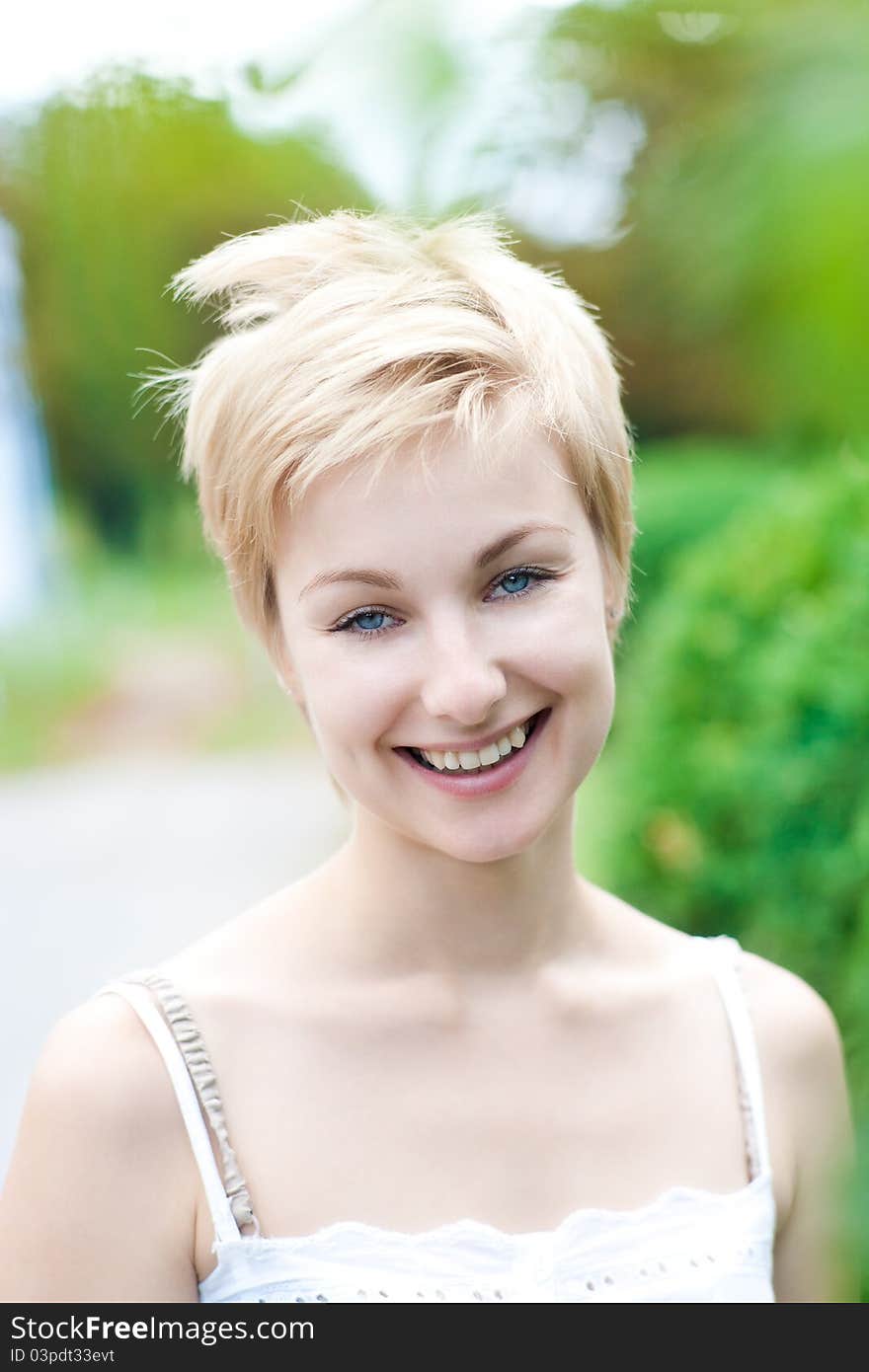 Portrait of young smiling female posing on the nature. Portrait of young smiling female posing on the nature.