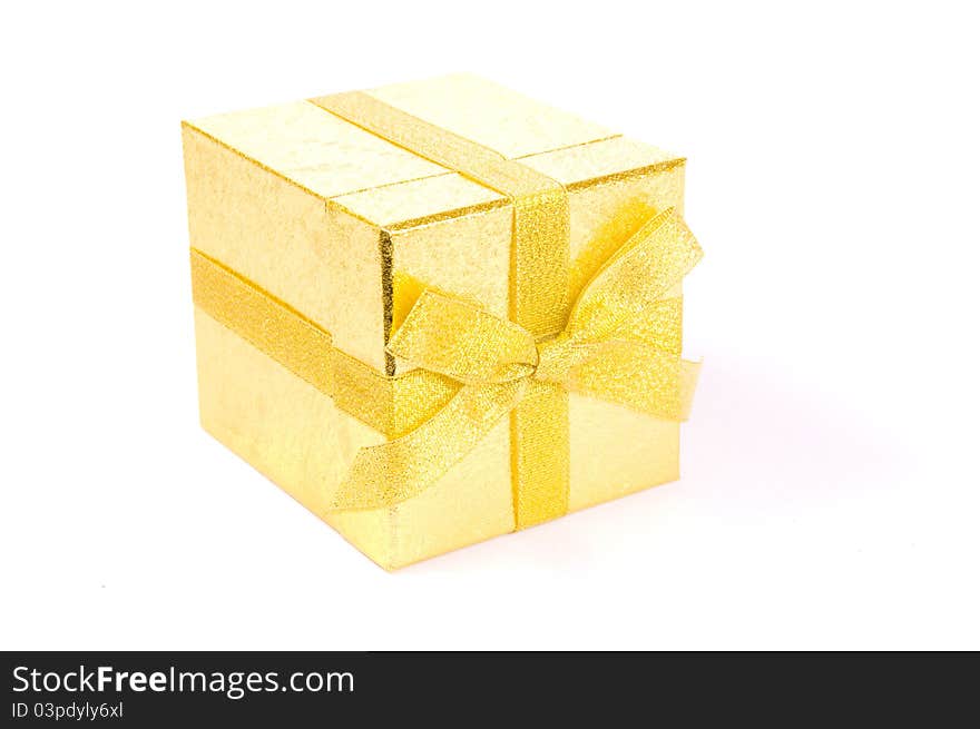 Christmas golden gift-box on white background, with golden ribbon. Christmas golden gift-box on white background, with golden ribbon