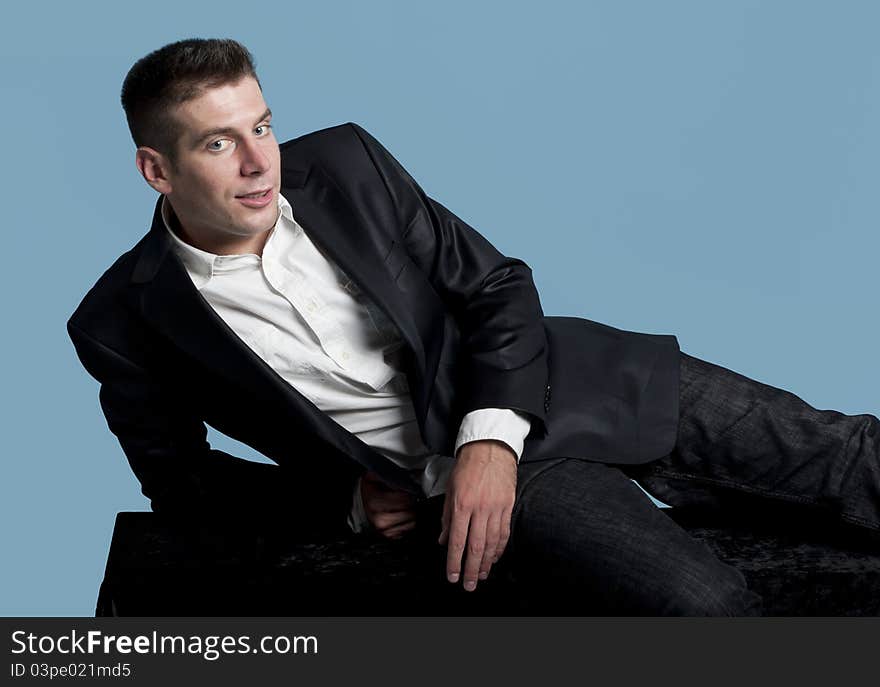 Young man lying on a bench and smiling