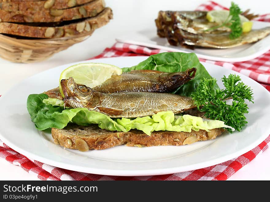 Smoked sprats on a slice of bread