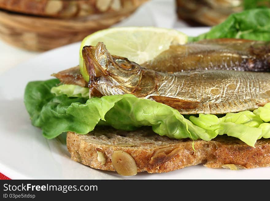 Smoked sprats on a slice of bread