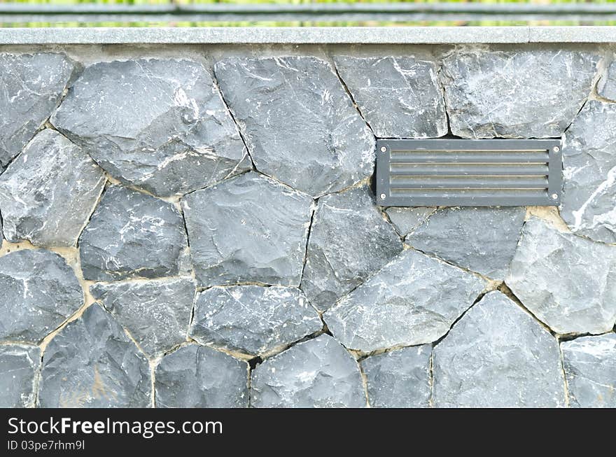 Electric lamp with gray stone wall background