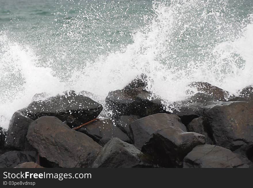 Water hitting a build of stones. Water hitting a build of stones