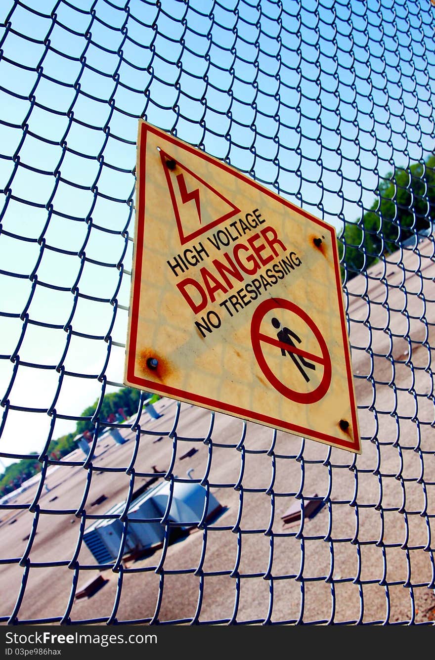 An high voltage-Danger sign on a fence. An high voltage-Danger sign on a fence