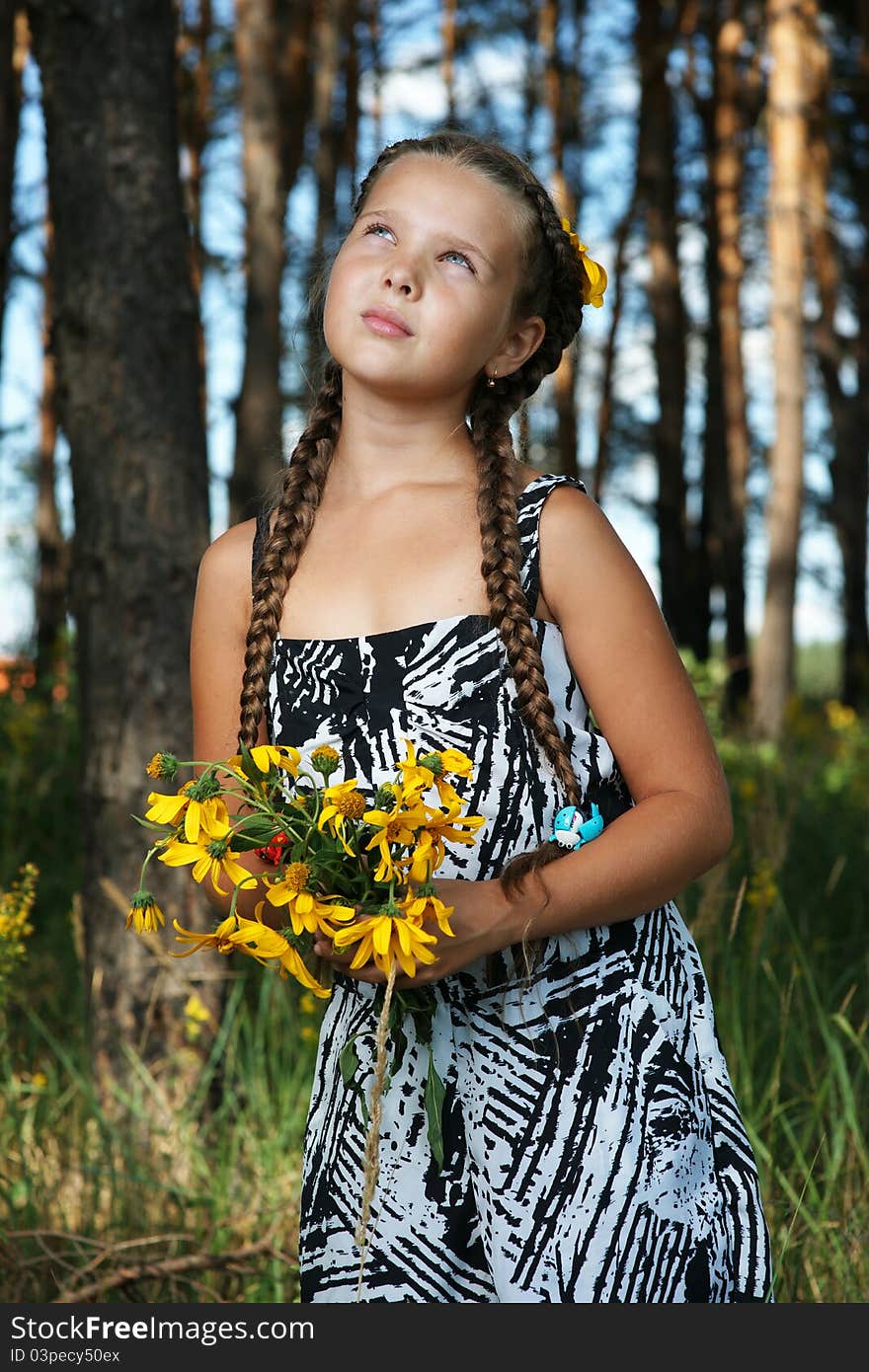 The girl in wood with a bunch of flowers