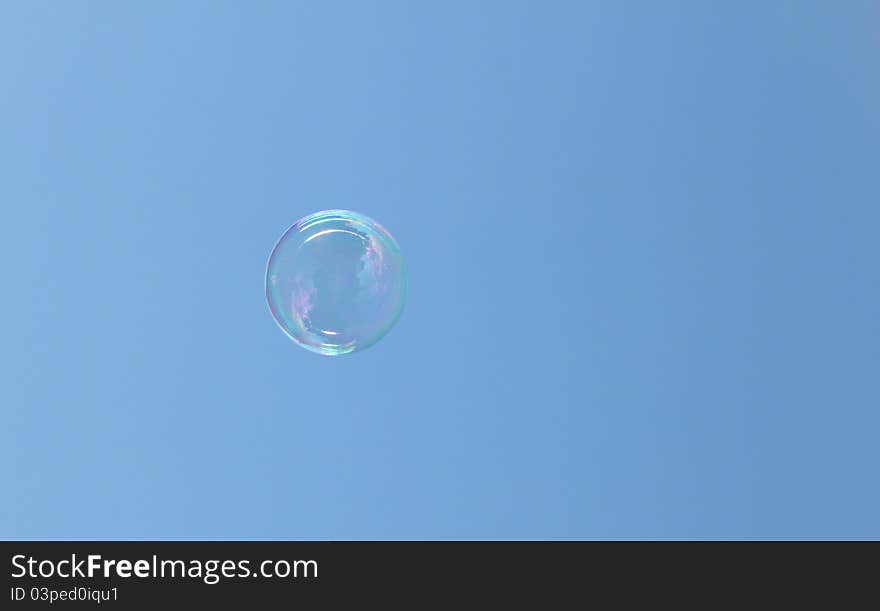 Bubble floating in the sky reflecting the sun and clouds. Bubble floating in the sky reflecting the sun and clouds