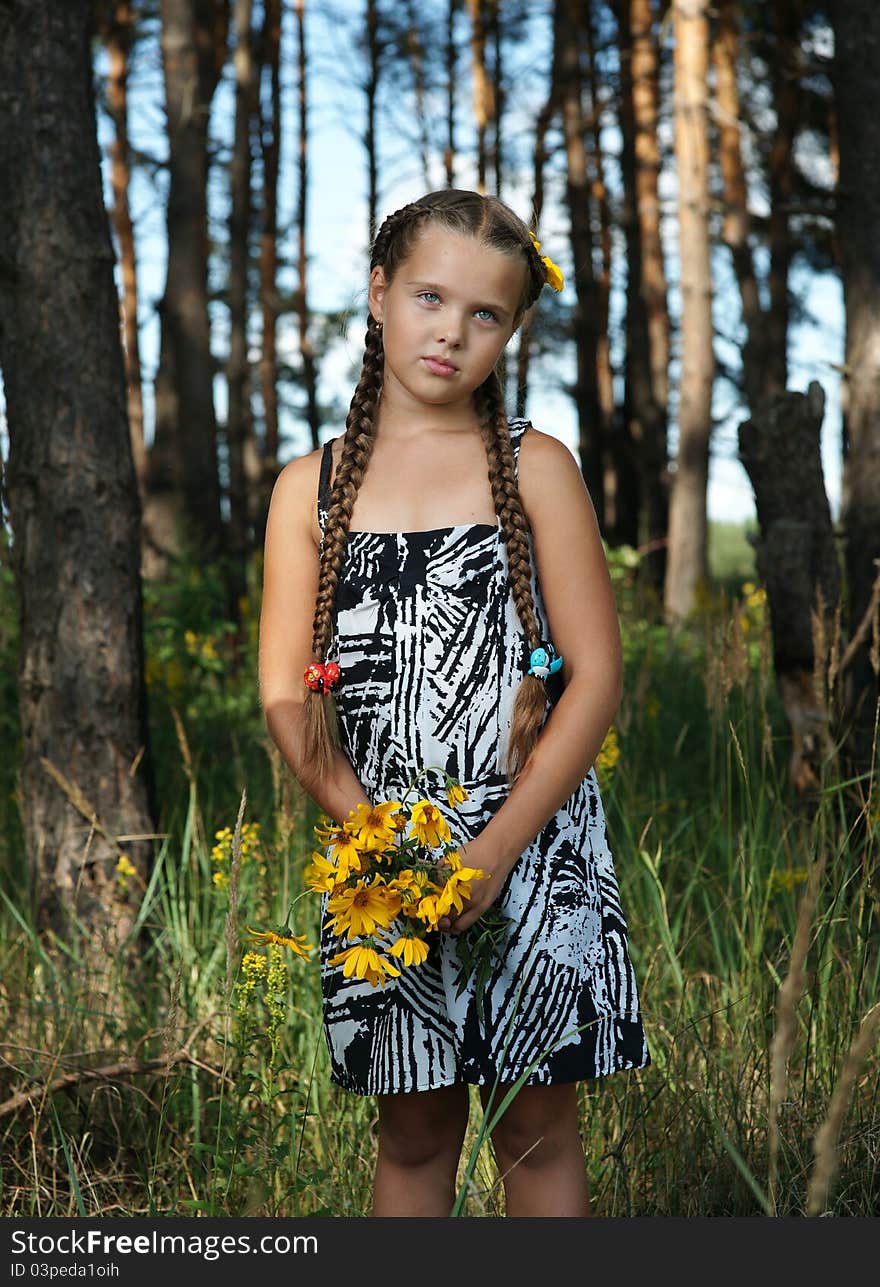 The girl in wood with a bunch of flowers