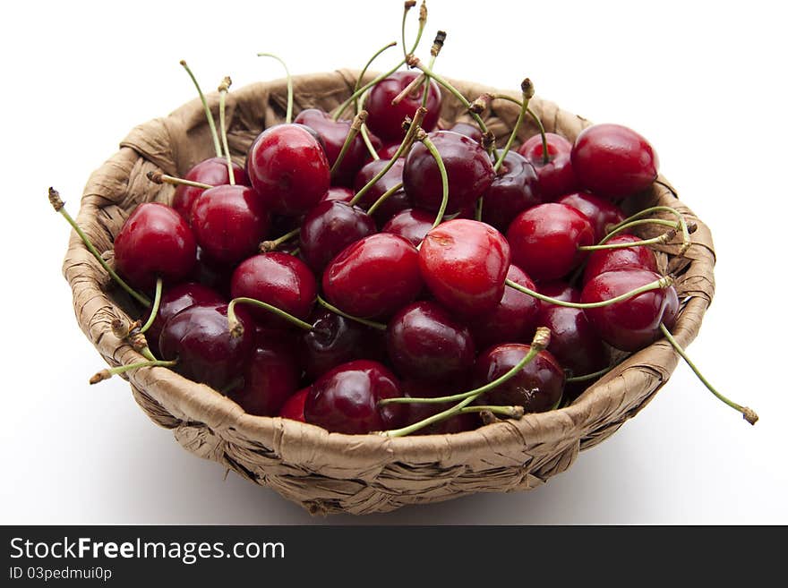 Red cherries with stem in the basket. Red cherries with stem in the basket