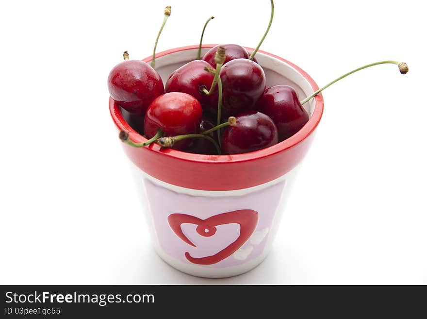 Red cherries with stem in the cup. Red cherries with stem in the cup