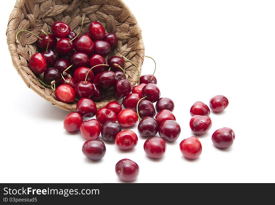 Red cherries with stem in the basket