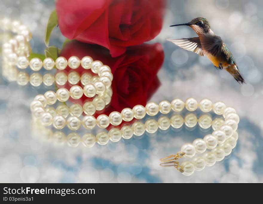 Hummingbird and Elegant pearls over glass with clouds and rose very shallow depth of field