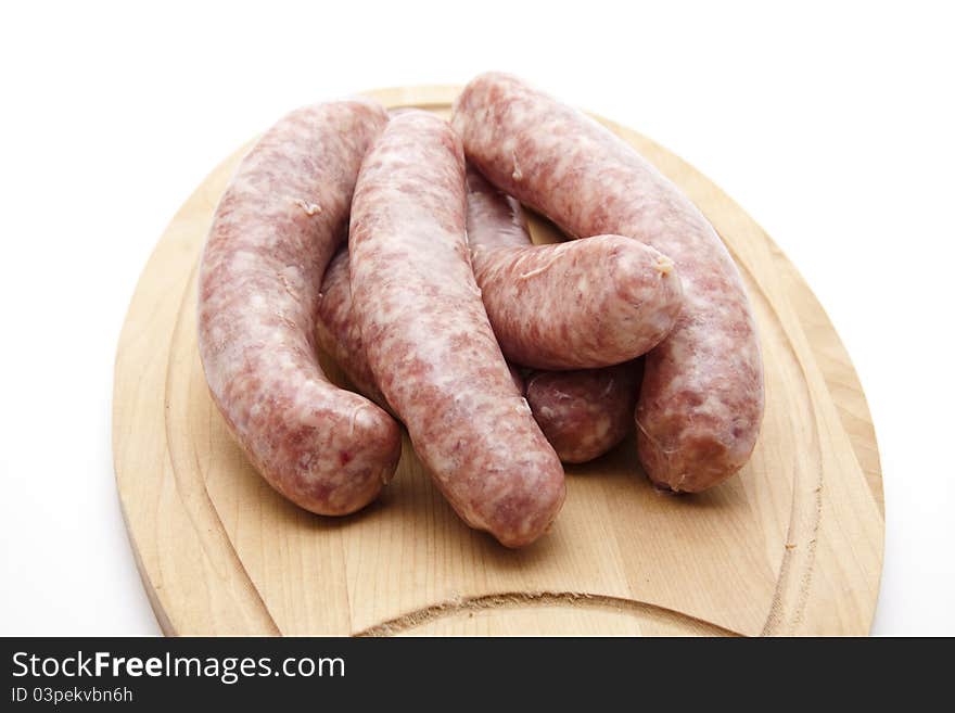 Coarse raw fried sausage onto wood plates