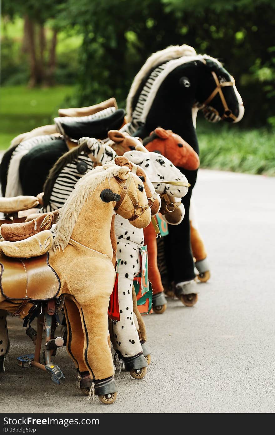 Toy horses in a park