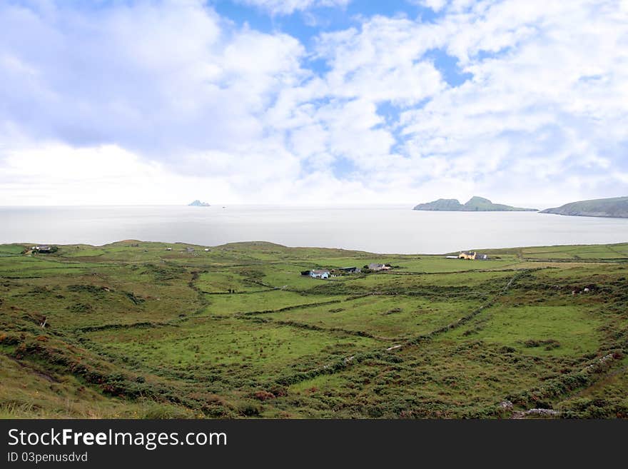 Green irish fields and skellig rock view