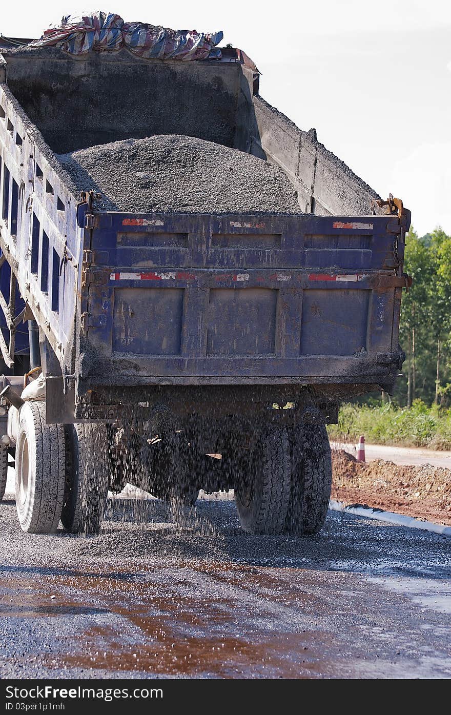 The car is Poured out asphalt on road. The car is Poured out asphalt on road