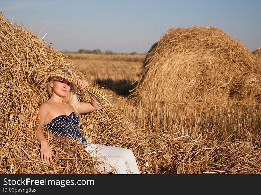 The beautiful girl in the field with wheat