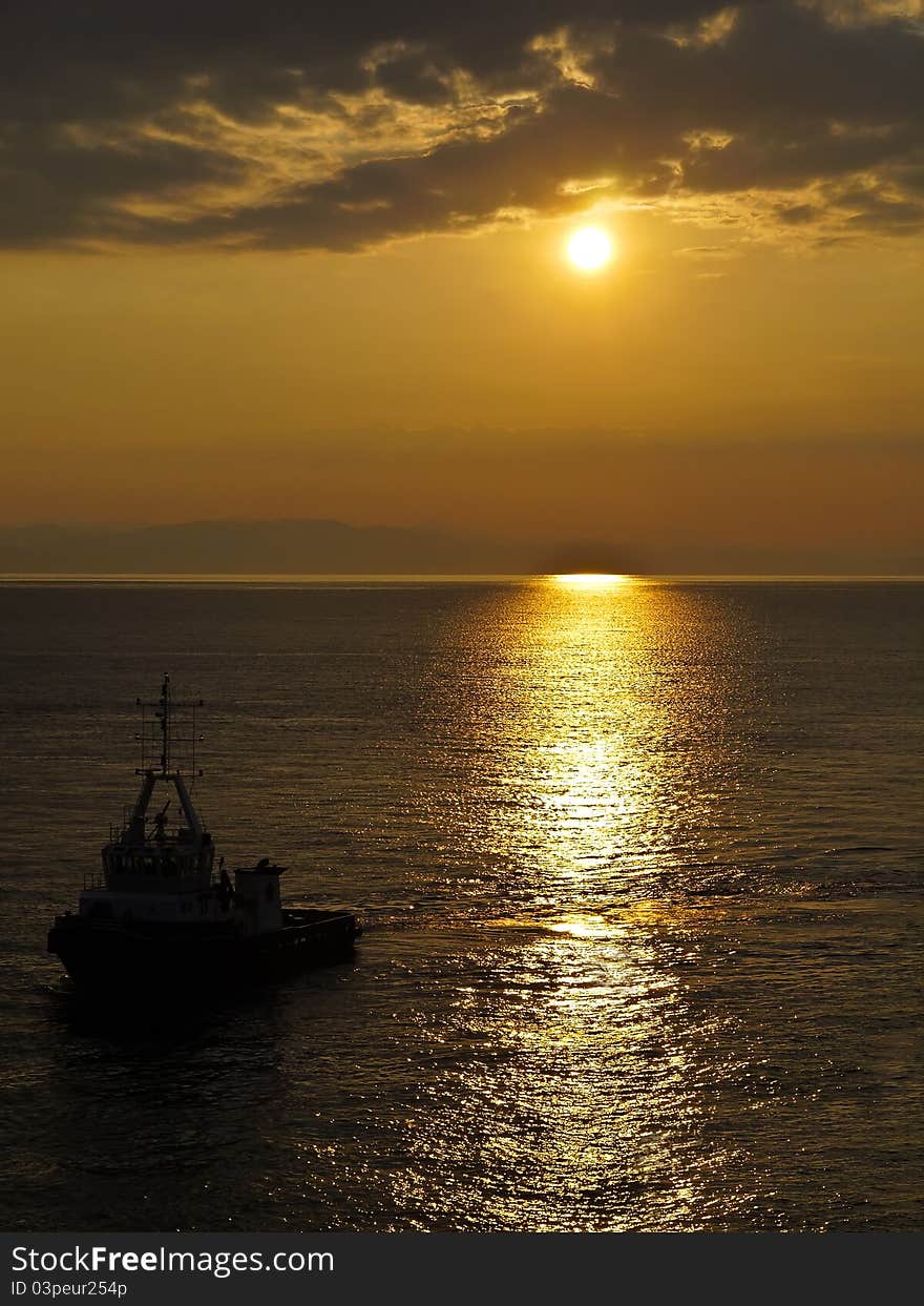 Carrier ship at sunset in the sea