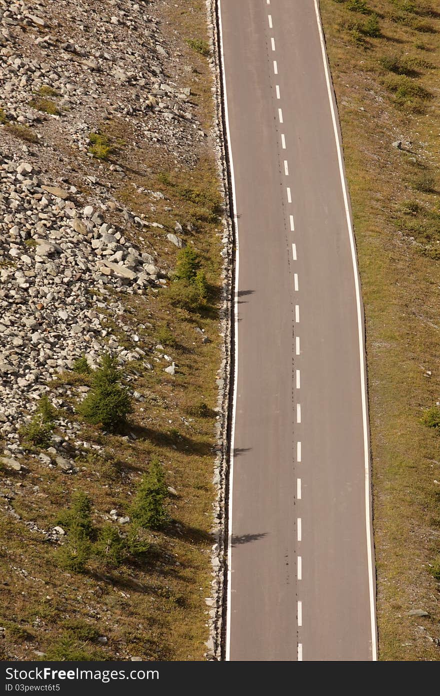 The asphalt road with no traffic in the swiss landscape. The asphalt road with no traffic in the swiss landscape.