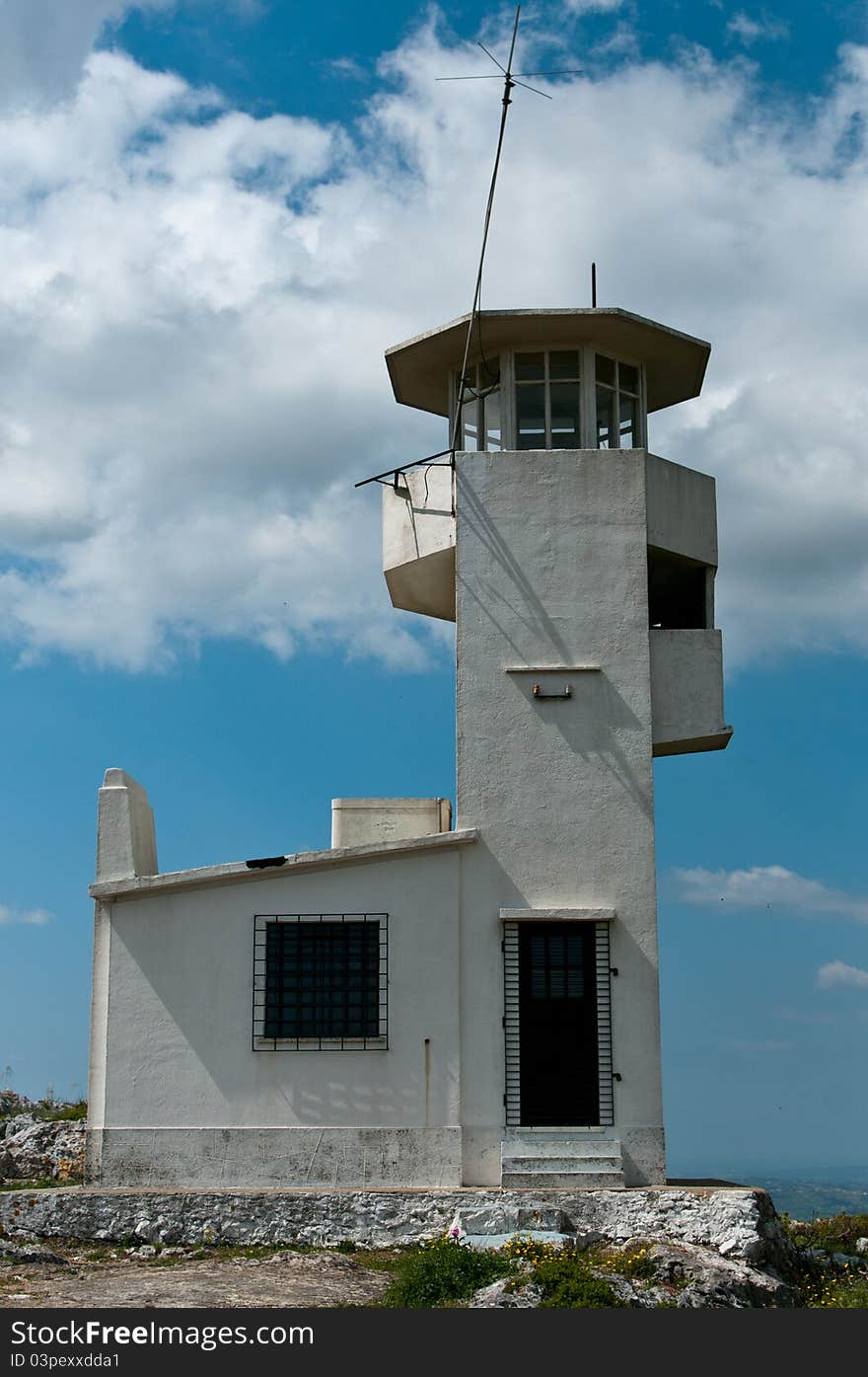 Old military tower against blue sky and clouds