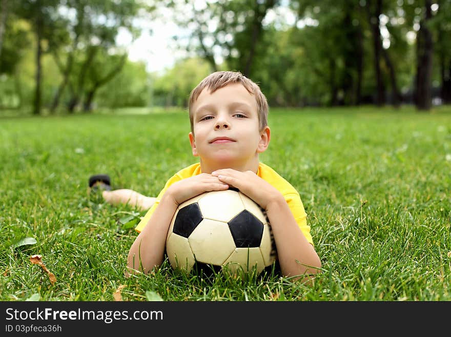 Little boy in the park with a ball