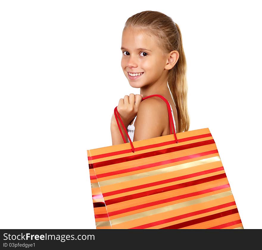 Pretty teenage girl with shopping bags in studio against white background